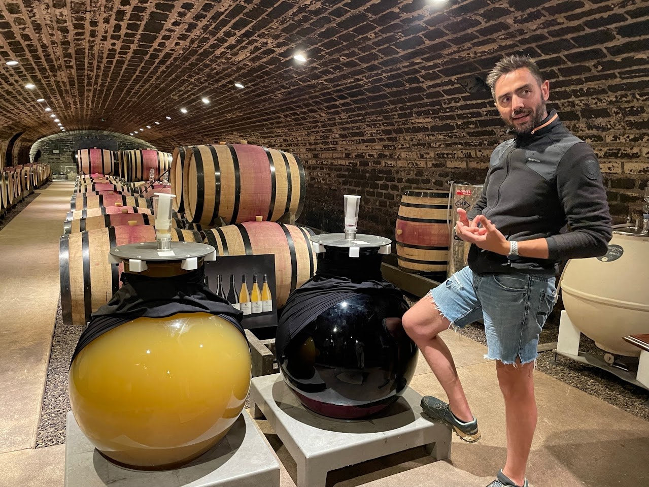 Barrels and glass globes in a Burgundy cellar