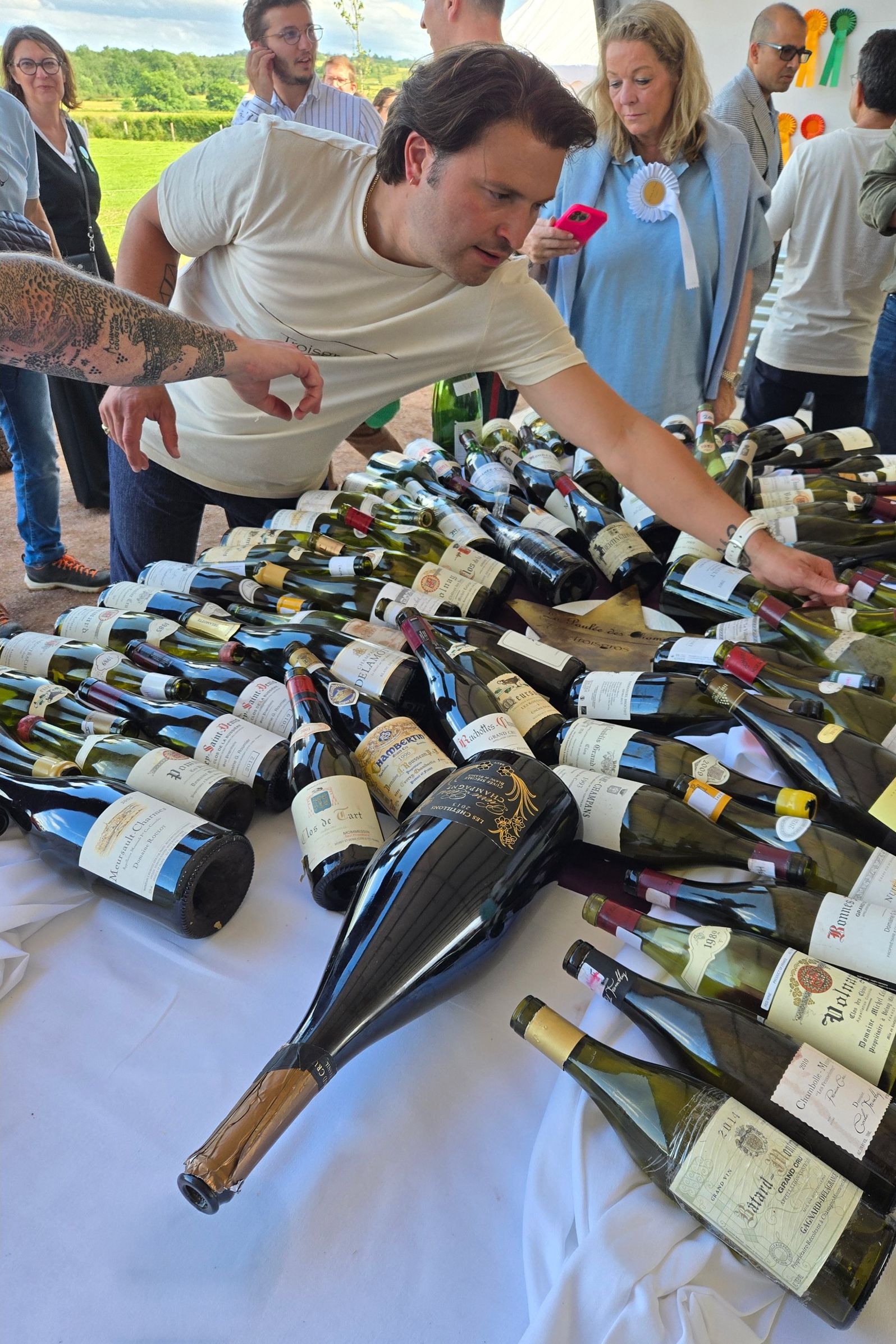 Guests choosing from a table of open bottles